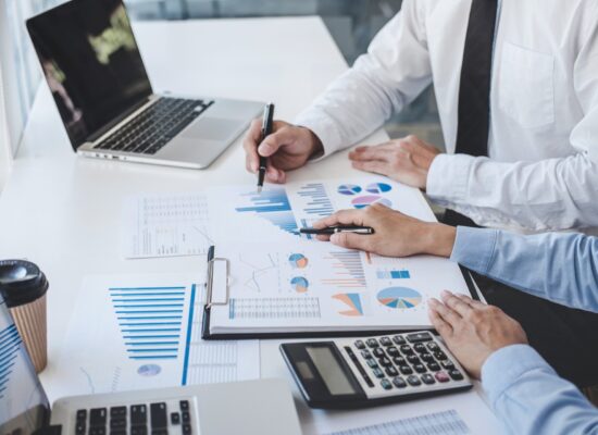 Teamwork of business colleagues consultation market growth on financial document graph report statistics, professional occupation working analyzing investment project to development grow to success.